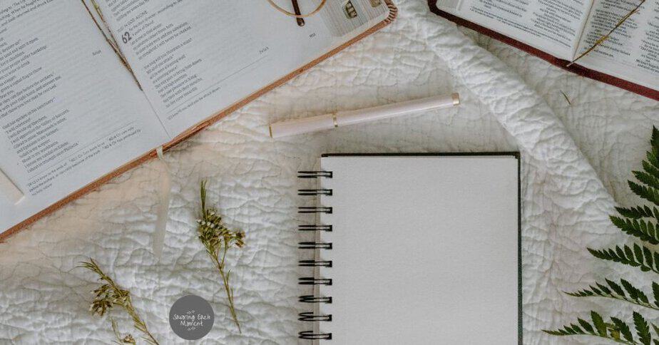 Bible and spiral notebook with a pretty pen for taking notes on the Bible study for women.