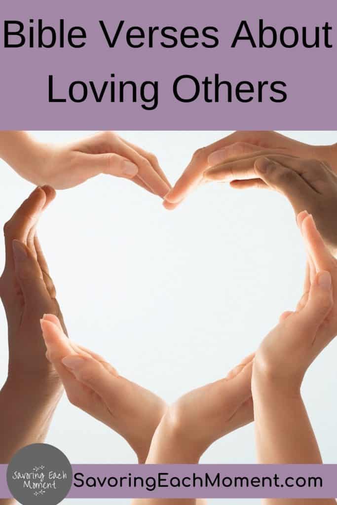 heart shape made with hands after reading Bible verses about loving others