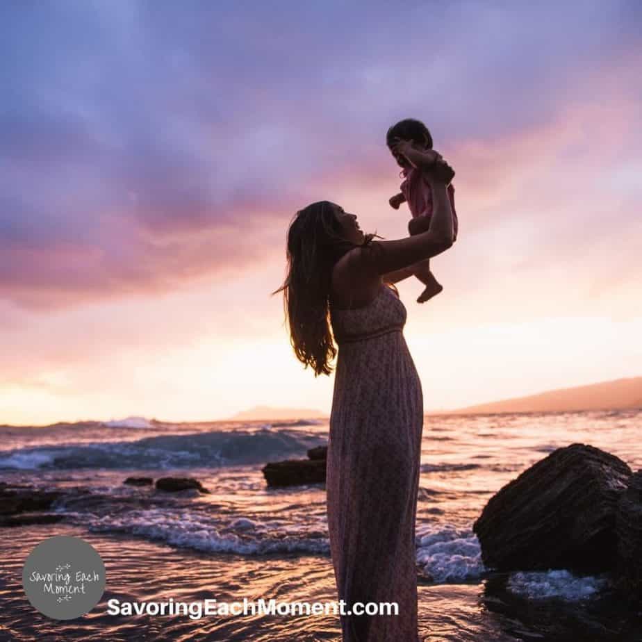 mother with baby in her arms as she thinks about bible verses about mothers