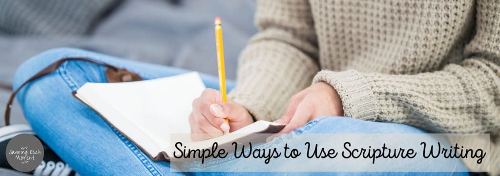 woman sitting cross-legged writing in a journal