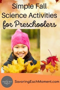 Preschool girl holding a bunch of yellow leaves while doing simple fall science activities for preschoolers