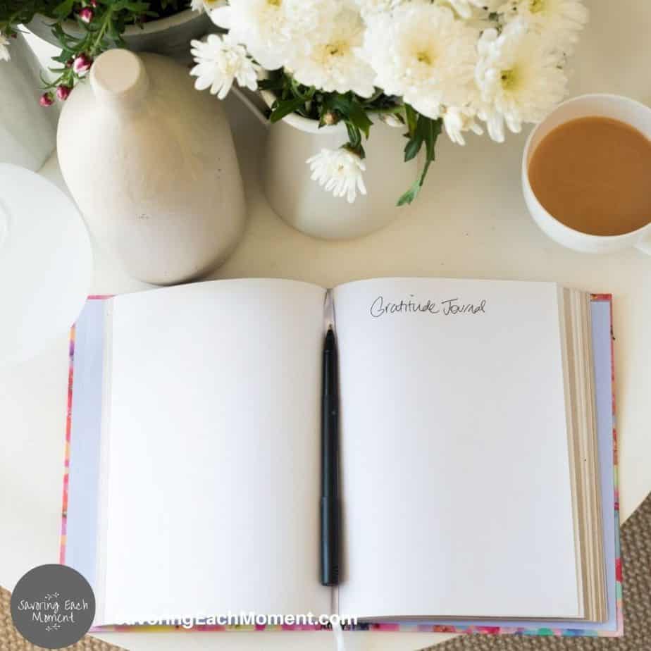 prayer journal opened up with a pen in the center of the book