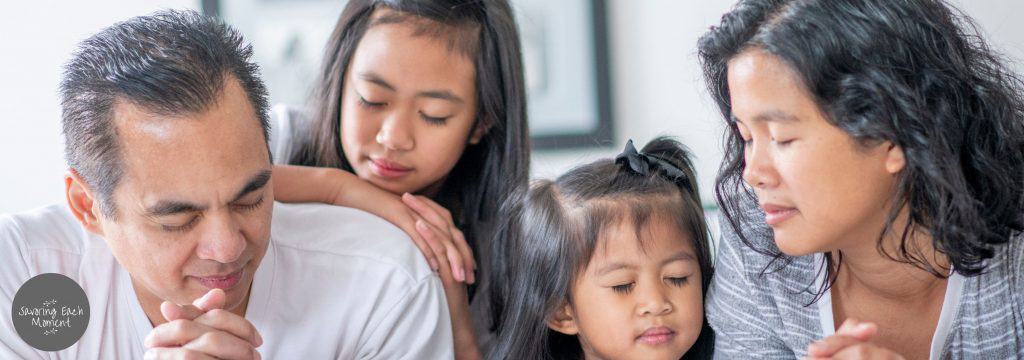 family praying together at bedtime