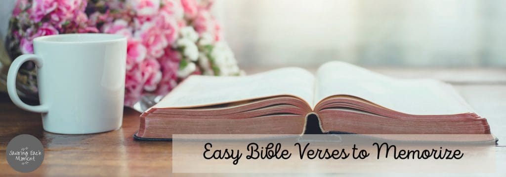 Bible laying open on a table with a bunch of flowers in the background