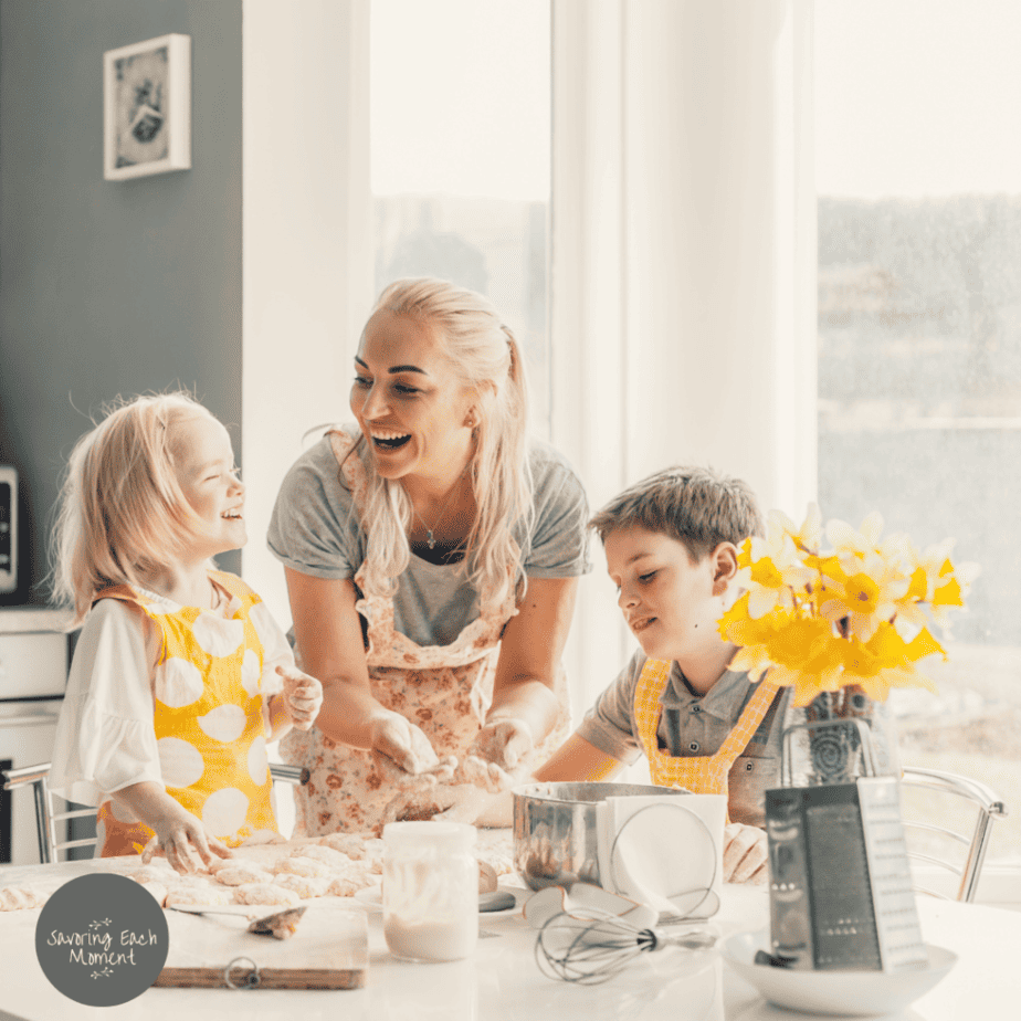 Mom with her children in the kitchen working on how to be a good mom.
