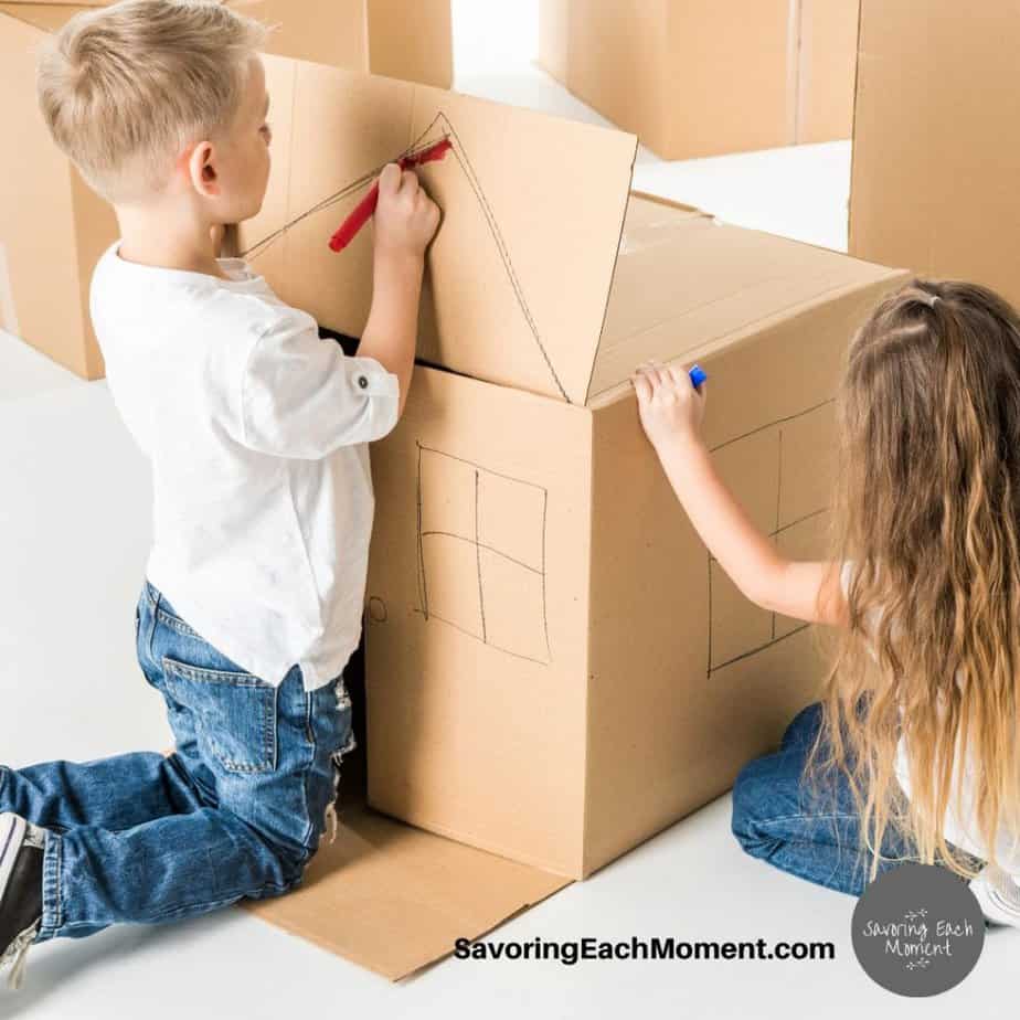 preschool kids drawing a house on a box
