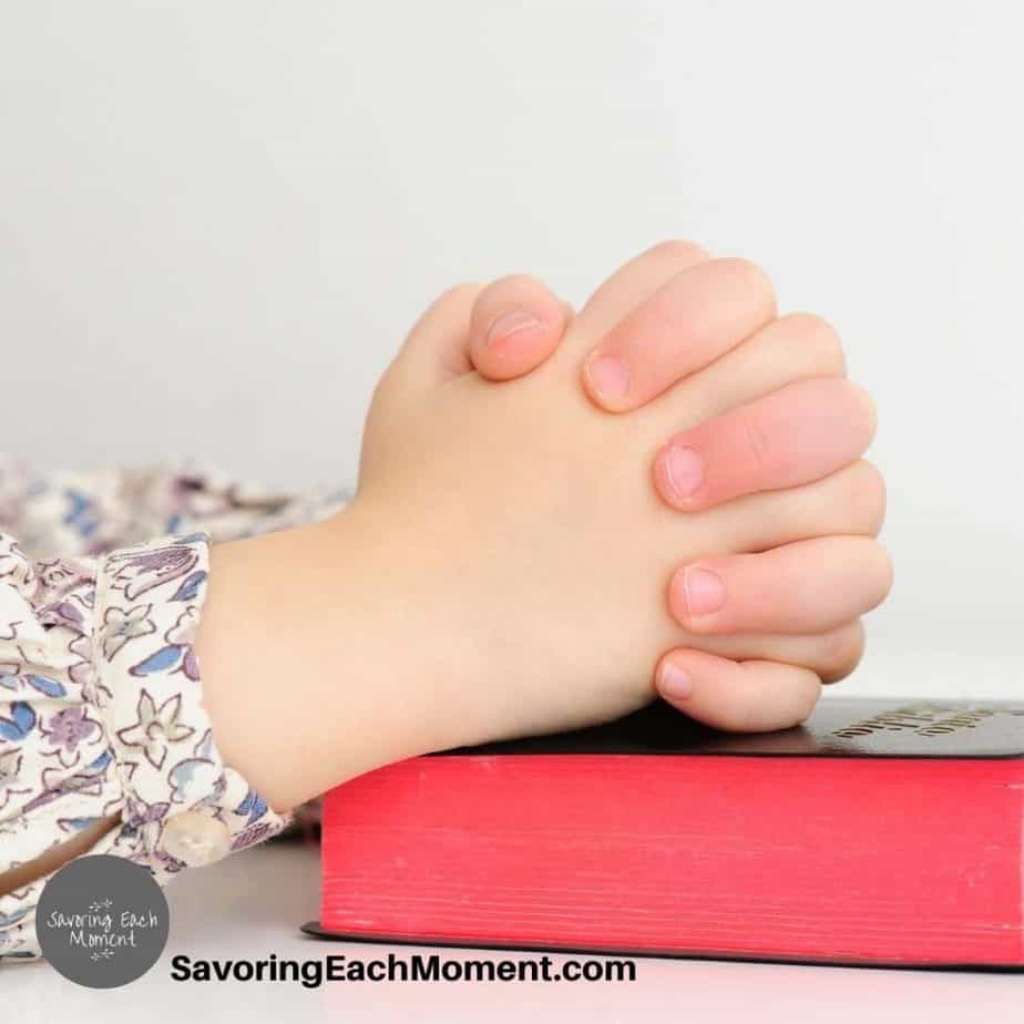 child's hands folded in prayer